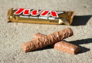 A Twix candy bar is pictured to simulate a log-like dog poop.