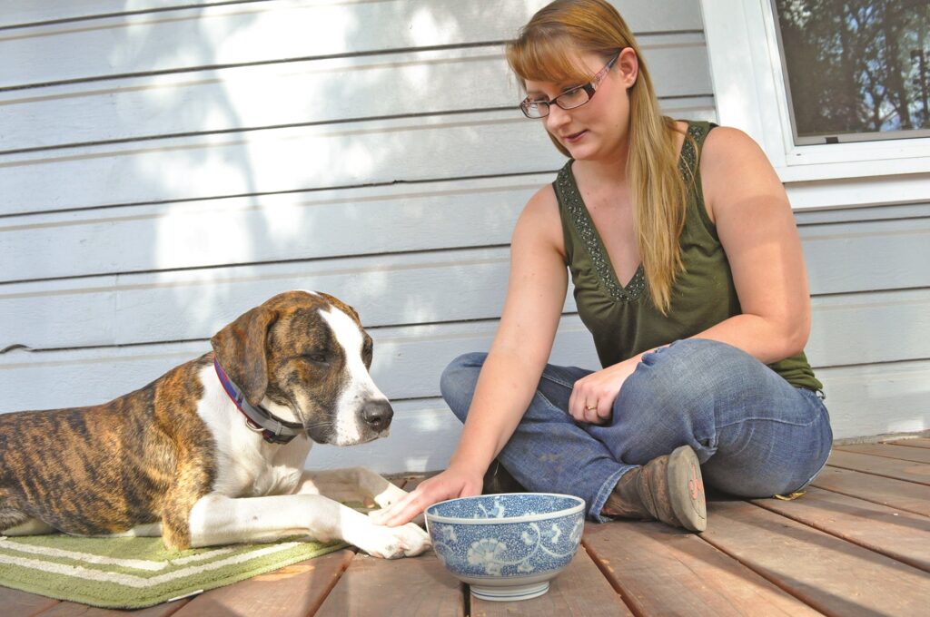 playing bucket game with dog