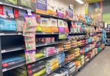 An array of dry dog food displayed in the aisle of a local pet store.
