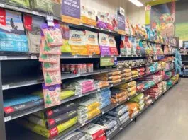 An array of dry dog food displayed in the aisle of a local pet store.
