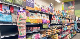 An array of dry dog food displayed in the aisle of a local pet store.