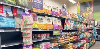 An array of dry dog food displayed in the aisle of a local pet store.