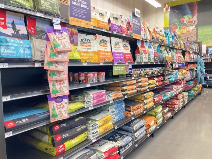 An array of dry dog food displayed in the aisle of a local pet store.