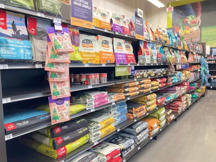 An array of dry dog food displayed in the aisle of a local pet store.