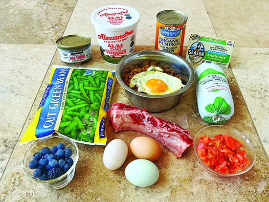 diet_addons_less fat Healthy dog food additives like fruit and eggs can boost your dog's nutritional intake.
