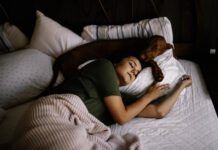 Should your dog sleep in your bed? There are several pros and cons.
