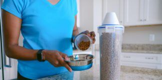 Woman Pours Pet Food Into Bowl