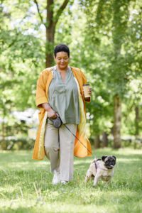 Black Woman Walking Dog in Park