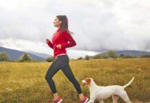 Young woman jogging with her dog