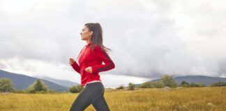 Young woman jogging with her dog