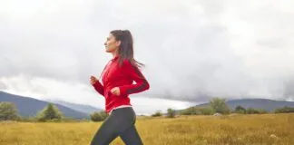 Young woman jogging with her dog