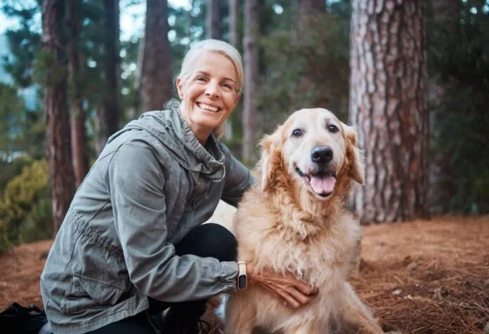 Shot of a senior woman out for a hike with her dog Shot of a senior woman out for a hike with her dog