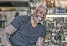 A black male mechanic in his auto repair shop