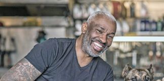 A black male mechanic in his auto repair shop