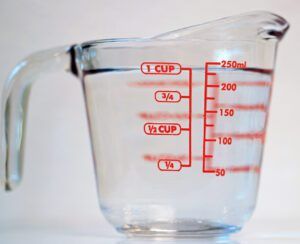 One cup of clear water against a white background