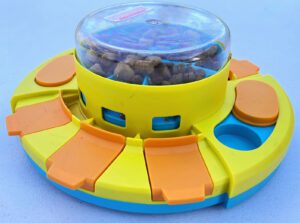 A high tier treat dispensing dog puzzle toy displayed against a plain background.