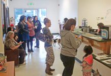 The lobby of an animal shelter crowded with people.