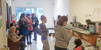 The lobby of an animal shelter crowded with people.