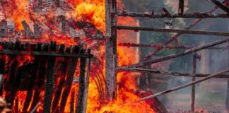 A fire in a residential neighborhood consumes a dog house.